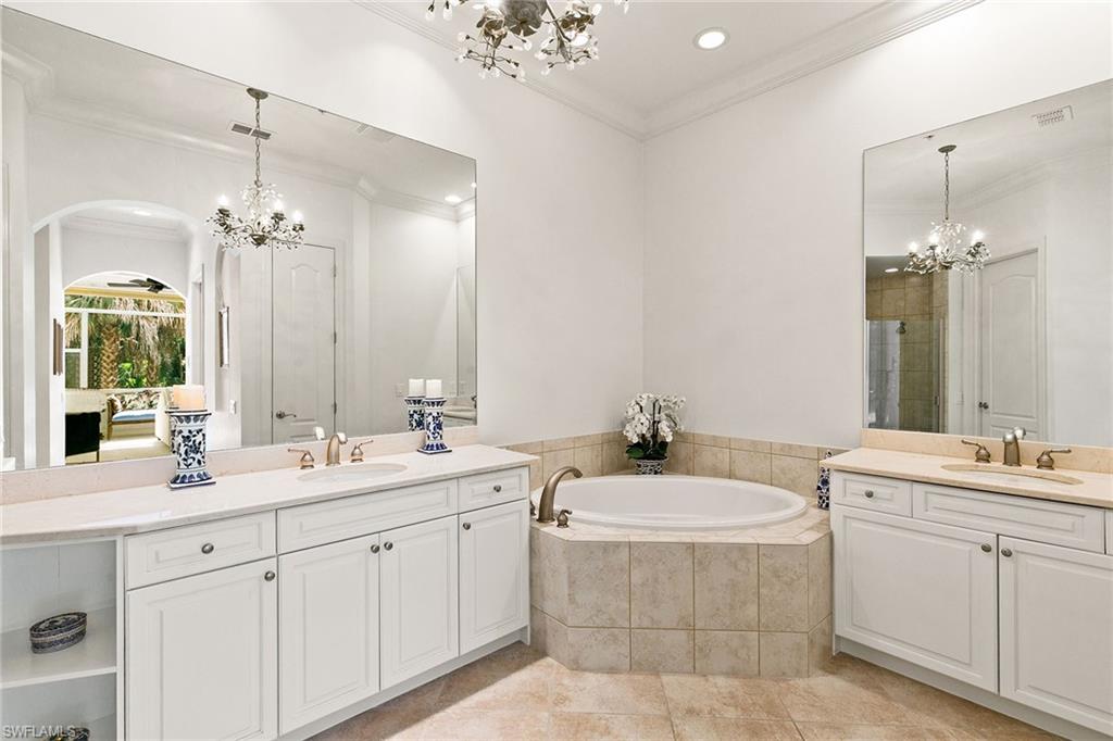 28540 Calabria Court, Unit 102 Naples, FL 34110 - Photo 24 of 32 a bathroom with a double vanity sink mirror and double