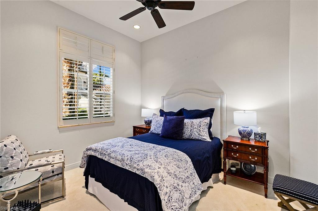 28540 Calabria Court, Unit 102 Naples, FL 34110 - Photo 28 of 32 a bedroom with a bed and a window