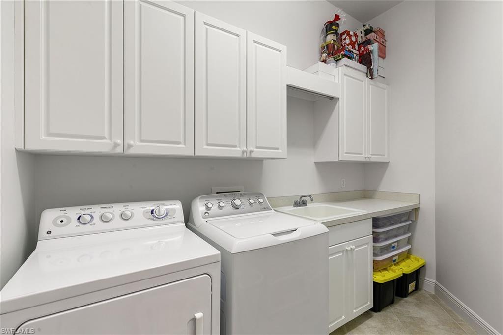 28540 Calabria Court, Unit 102 Naples, FL 34110 - Photo 29 of 32 a utility room with dryer and washer
