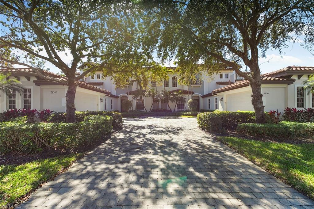 28540 Calabria Court, Unit 102 Naples, FL 34110 - Photo 9 of 32 a view of a house with a yard