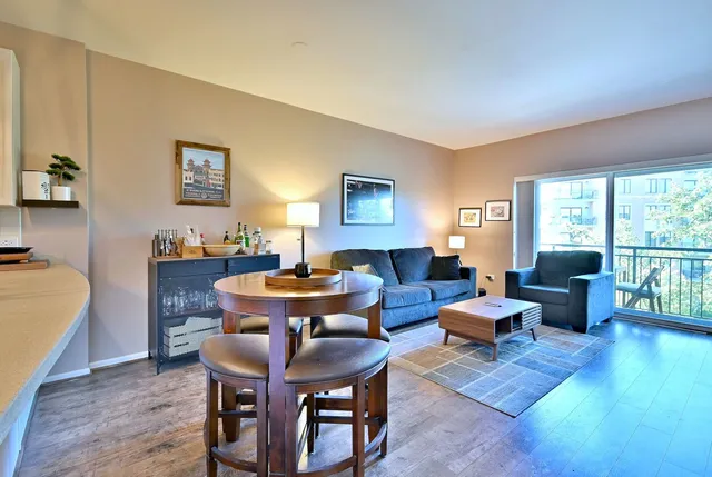 a living room with furniture a table and a large window