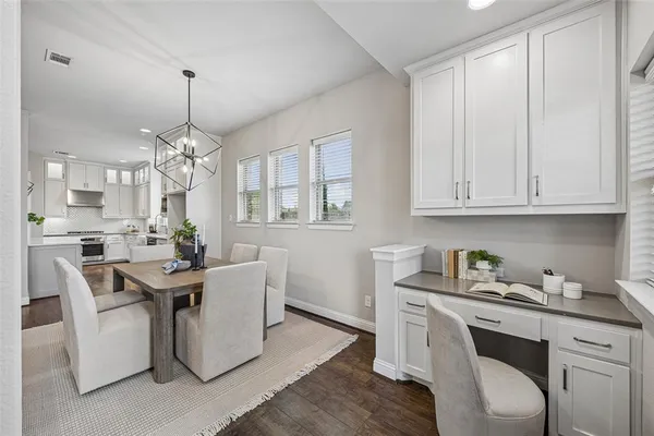 a kitchen with stainless steel appliances kitchen island granite countertop a sink cabinets and wooden floor