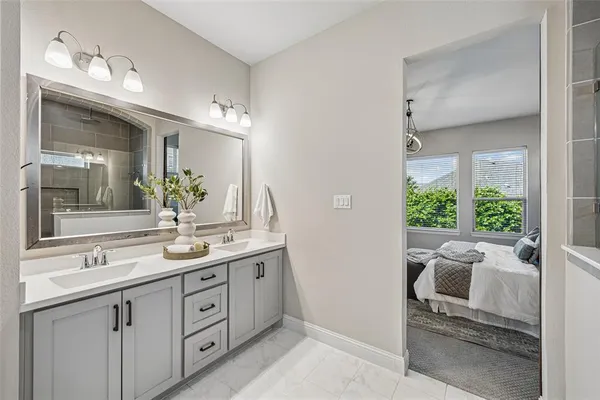 a spacious bathroom with a granite countertop sink and a mirror