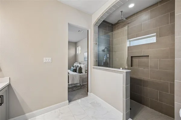 a room with a walk in closet and a bathroom