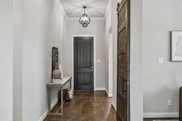a view of hallway with stairs and wooden floor