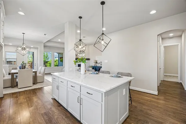 a view of a kitchen sink and wooden floor