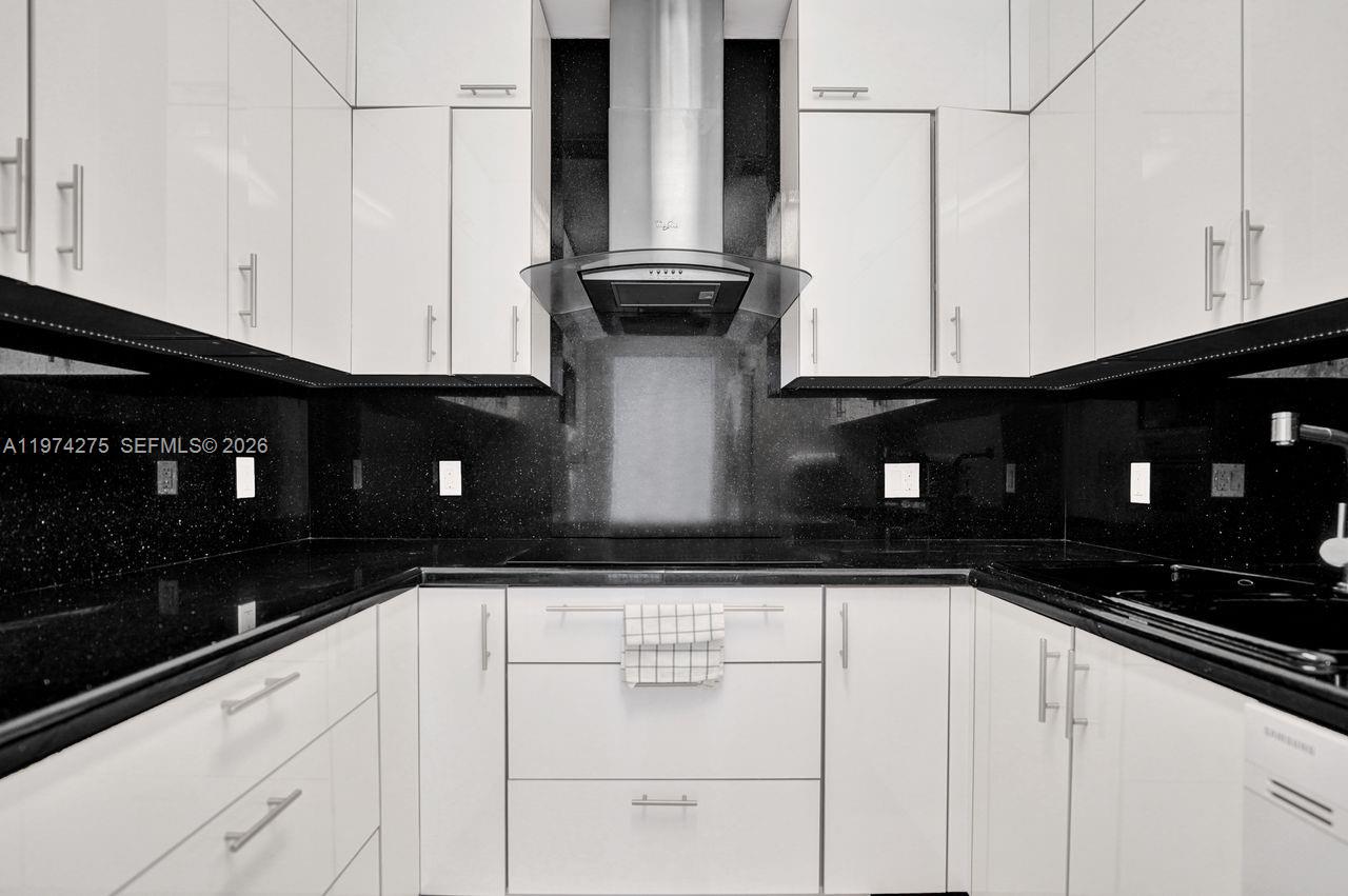 100 Lincoln Road, Unit PH12 Miami Beach, FL 33139 - Photo 13 of 59 a kitchen with granite countertop white cabinets and black appliances
