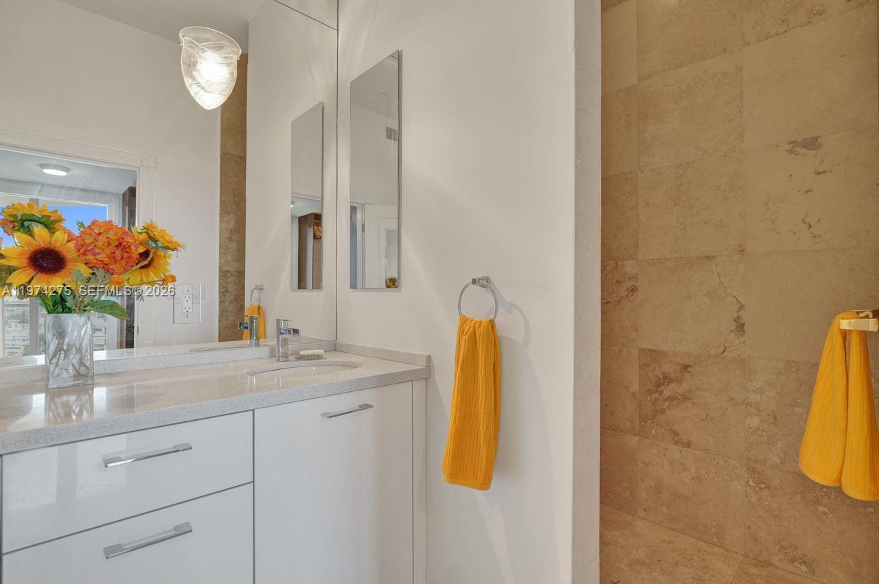 100 Lincoln Road, Unit PH12 Miami Beach, FL 33139 - Photo 28 of 59 a bathroom with a granite countertop sink and a mirror