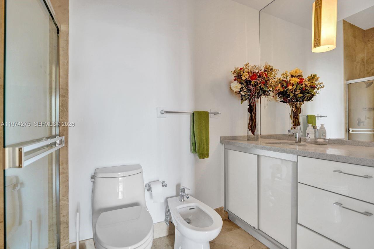 100 Lincoln Road, Unit PH12 Miami Beach, FL 33139 - Photo 36 of 59 a bathroom with a toilet sink and mirror