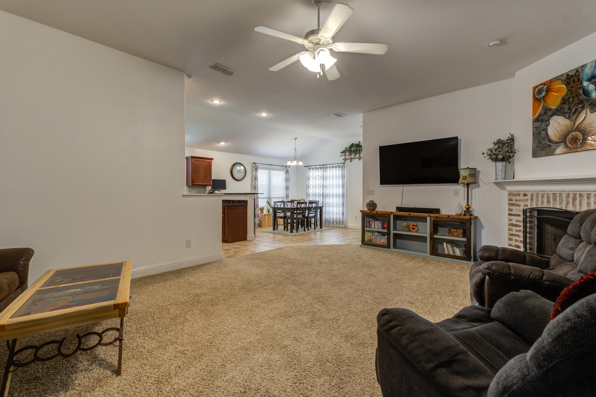 5747 110th Street Lubbock, TX 79424 - Photo 11 of 42 a living room with furniture and a flat screen tv