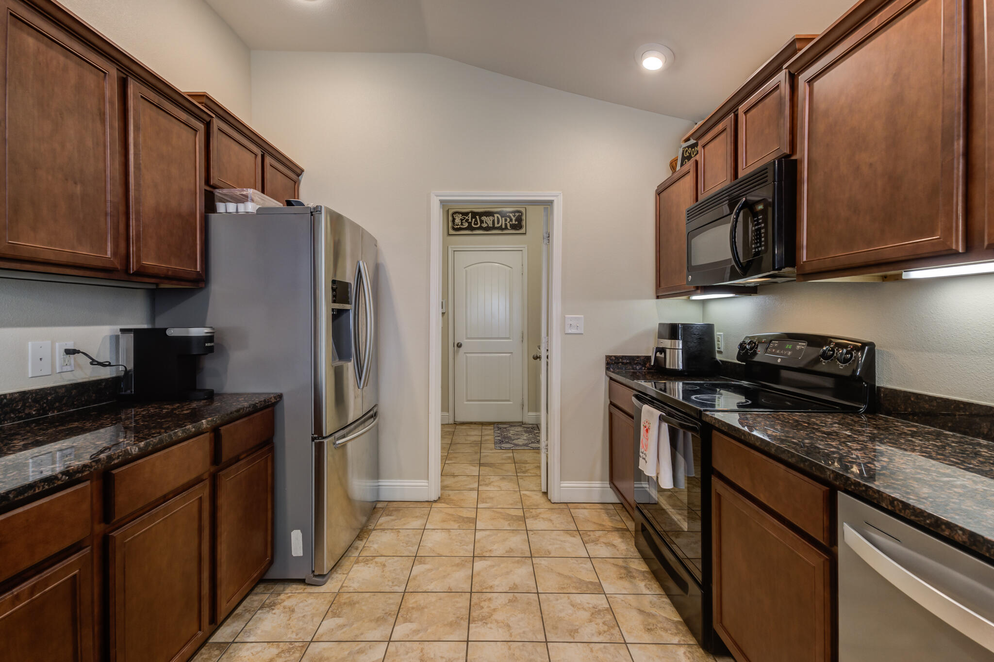 5747 110th Street Lubbock, TX 79424 - Photo 20 of 42 a kitchen with stainless steel appliances granite countertop a stove a refrigerator and a sink