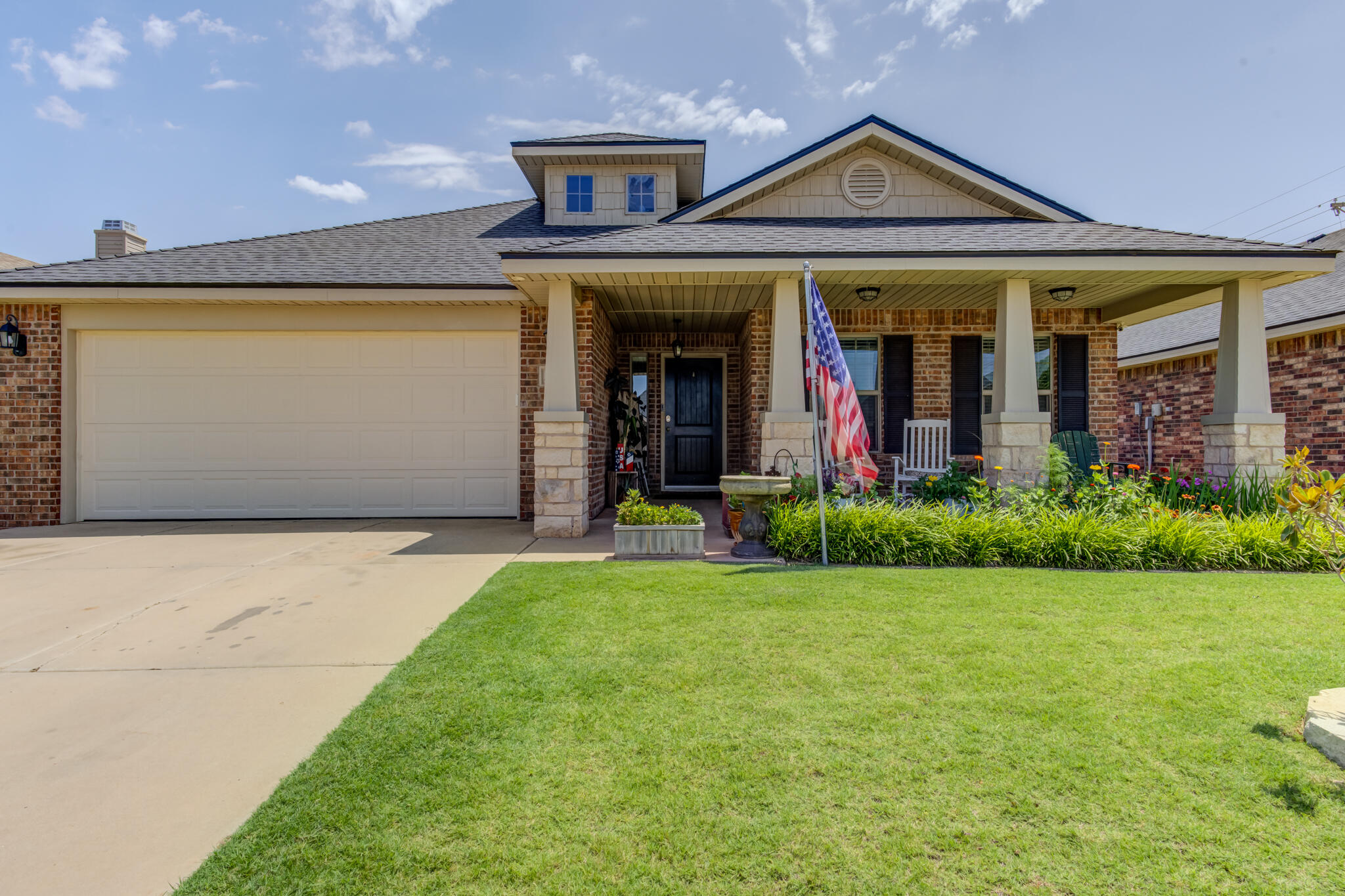 5747 110th Street Lubbock, TX 79424 - Photo 2 of 42 a front view of a house with garden