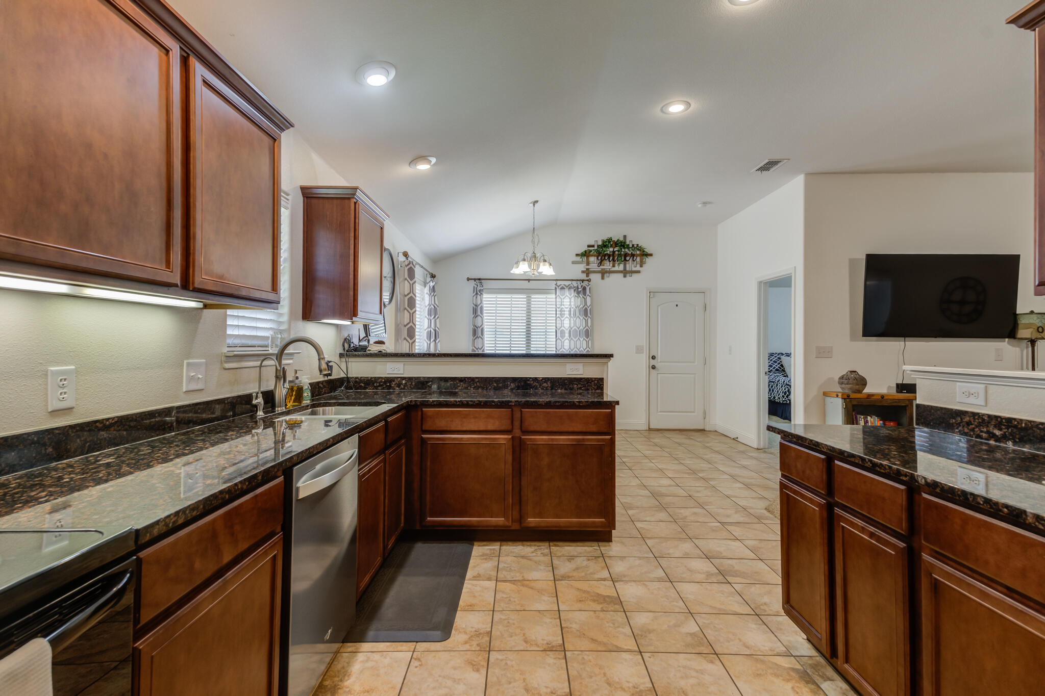 5747 110th Street Lubbock, TX 79424 - Photo 22 of 42 a kitchen with stainless steel appliances granite countertop a sink stove and cabinets