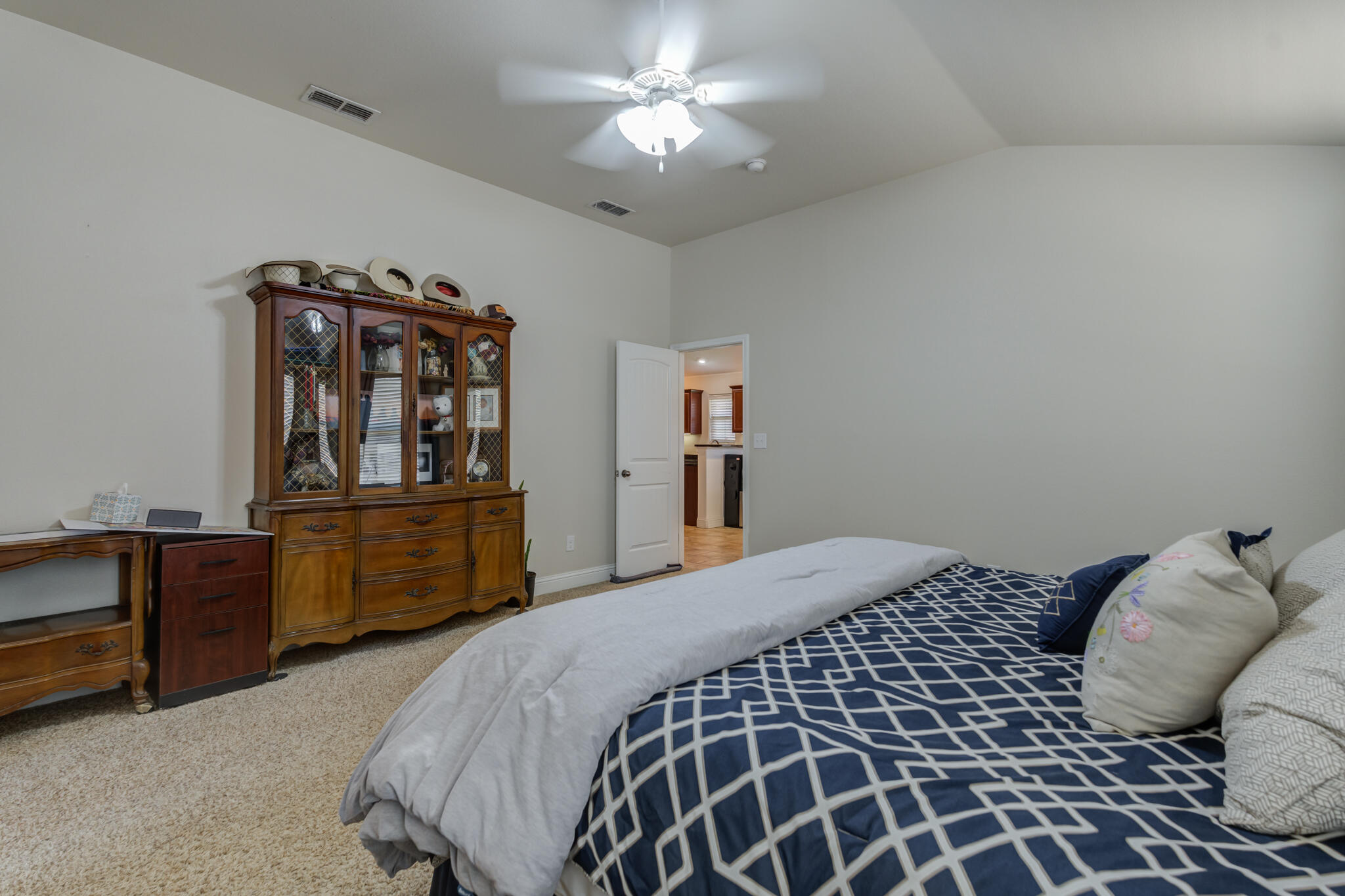 5747 110th Street Lubbock, TX 79424 - Photo 24 of 42 a bedroom with a bed and dresser
