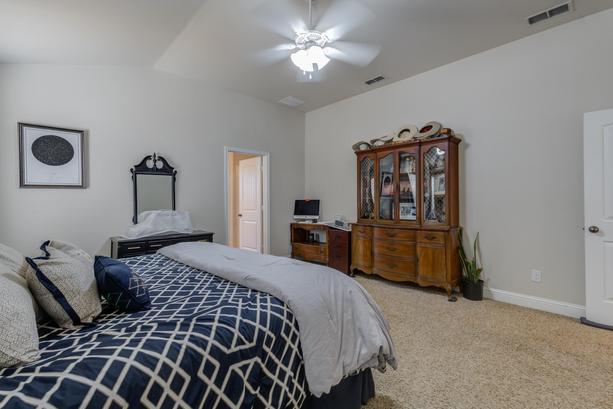5747 110th Street Lubbock, TX 79424 - Photo 25 of 42 a bedroom with a bed and dresser