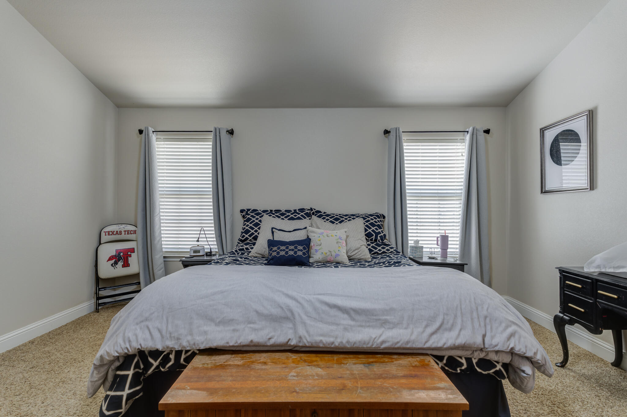 5747 110th Street Lubbock, TX 79424 - Photo 26 of 42 a bedroom with a bed two lamps and a large window