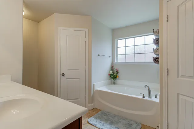 a white bath tub sitting next to a white sink