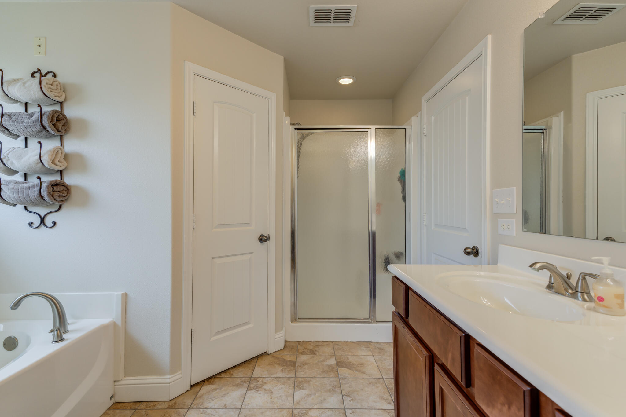 5747 110th Street Lubbock, TX 79424 - Photo 29 of 42 a bathroom with a sink and a mirror