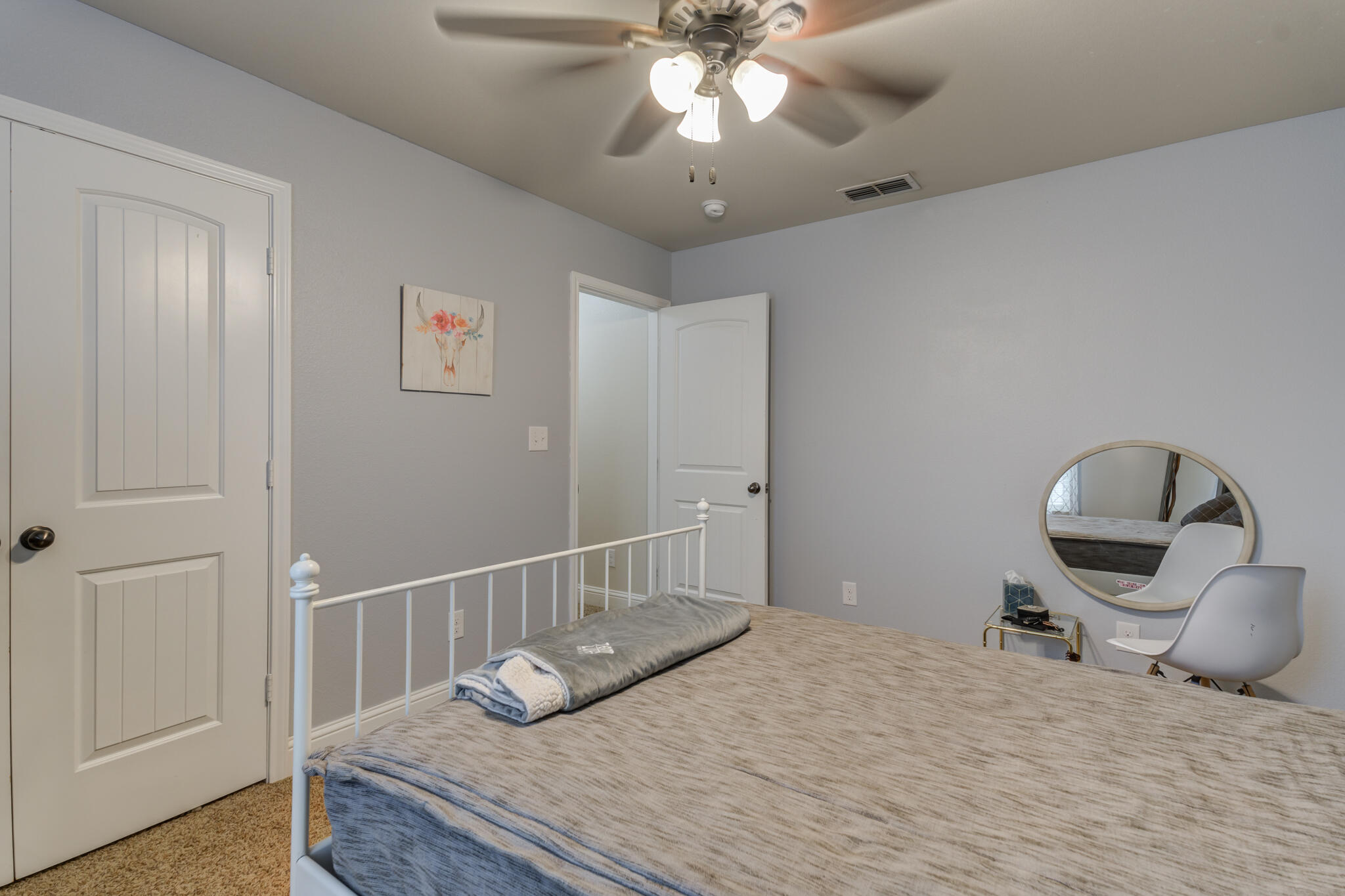 5747 110th Street Lubbock, TX 79424 - Photo 31 of 42 a bedroom with a bed and a chandelier