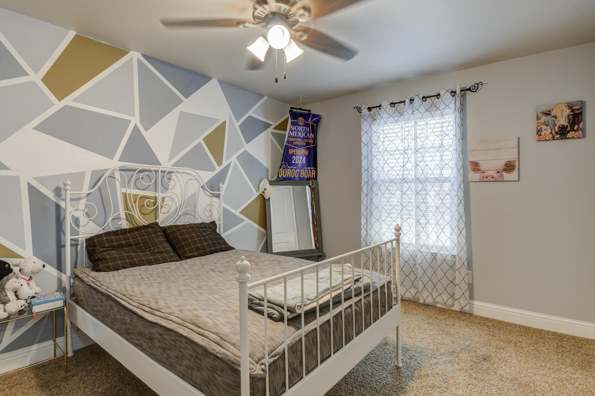 5747 110th Street Lubbock, TX 79424 - Photo 32 of 42 a bedroom with a bed and a chandelier