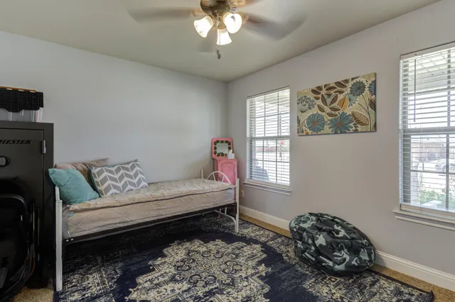 a bedroom with furniture and a window