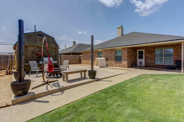 a view of a house with sitting area and garden