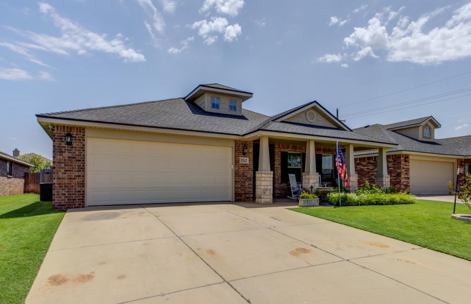 5747 110th Street Lubbock, TX 79424 - Photo 5 of 42 a front view of house with yard and green space