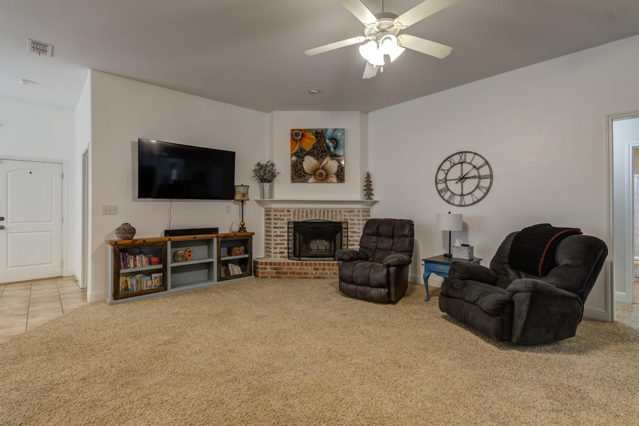 5747 110th Street Lubbock, TX 79424 - Photo 9 of 42 a living room with furniture and a flat screen tv