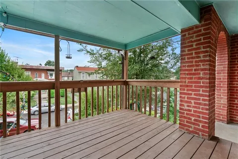 a view of balcony with wooden floor