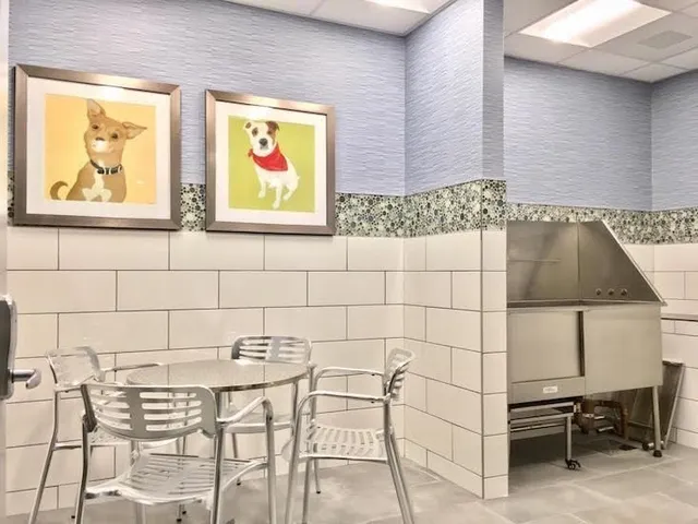 a bathroom with a sink and a painting on the wall