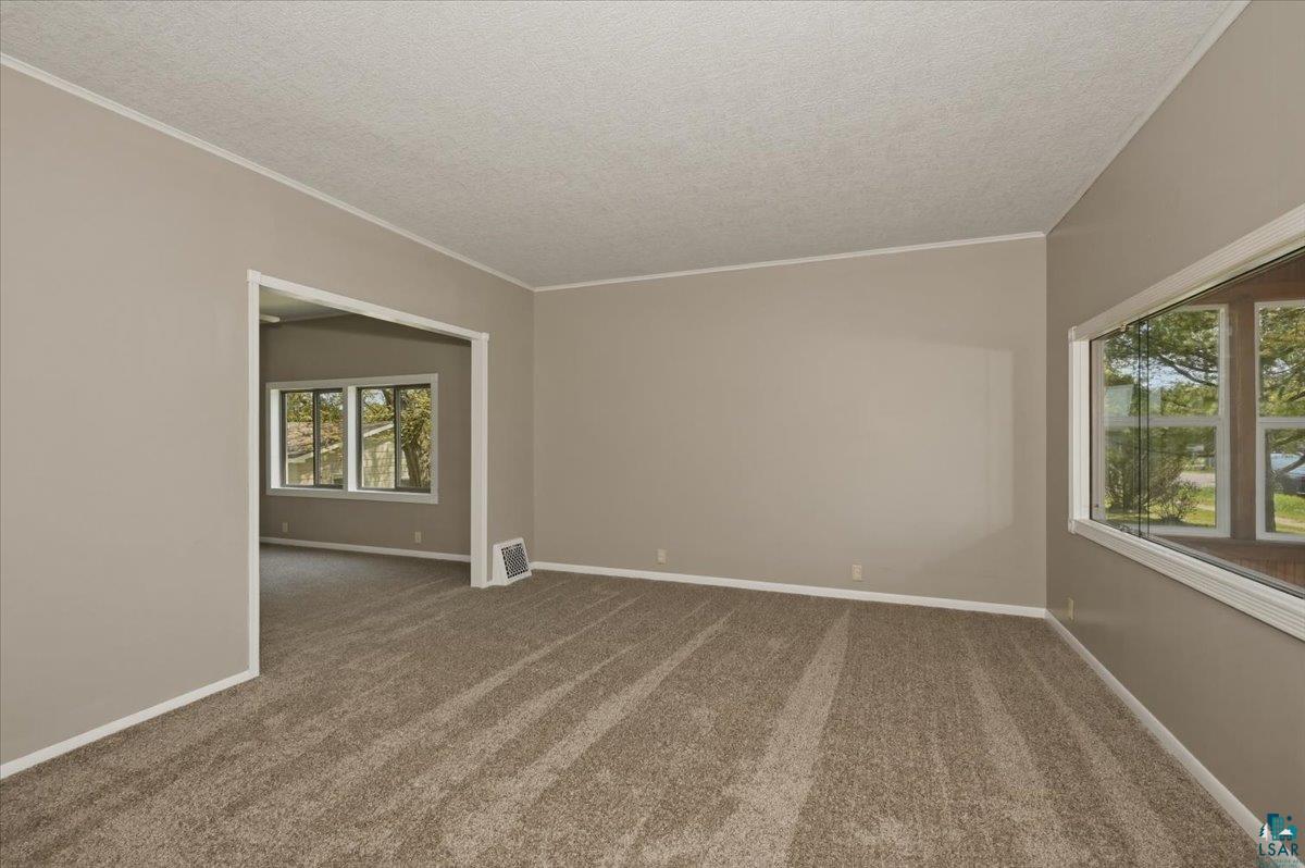 5319 East 3rd Street Superior, WI 54880 - Photo 19 of 33 Neutral-toned walls and plush carpet flooring define this spacious room