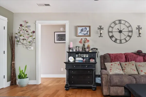 a living room with furniture and wooden floor