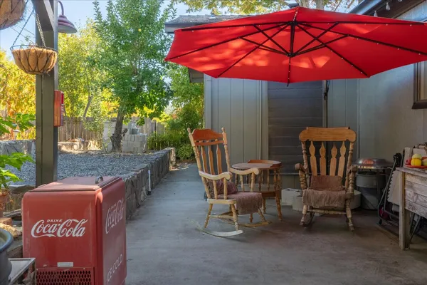 a patio with tables and chairs