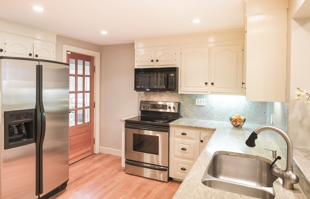 295 Concord Road Wayland, MA 01778 - Photo 12 of 30 a kitchen with stainless steel appliances granite countertop a stove a sink and a refrigerator