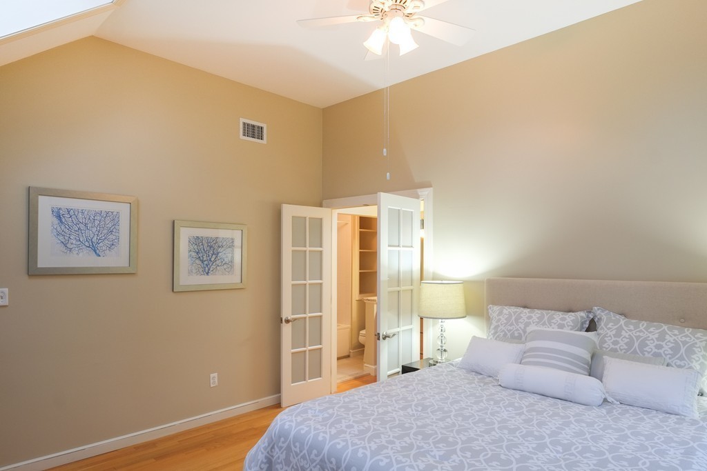 295 Concord Road Wayland, MA 01778 - Photo 16 of 30 a bedroom with a bed and a chandelier