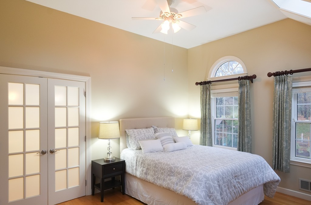 295 Concord Road Wayland, MA 01778 - Photo 4 of 30 a bedroom with a large bed and a chandelier