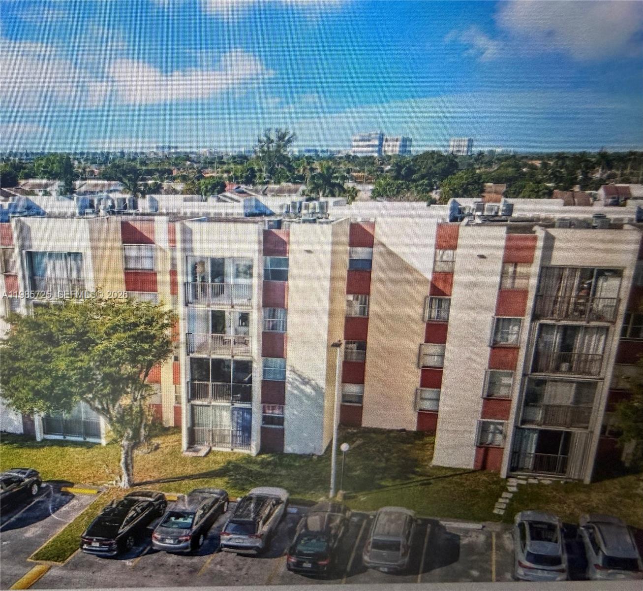 9441 Southwest 4th Street, Unit 111 Miami, FL 33174 - Photo 2 of 6 a view of a building with a yard