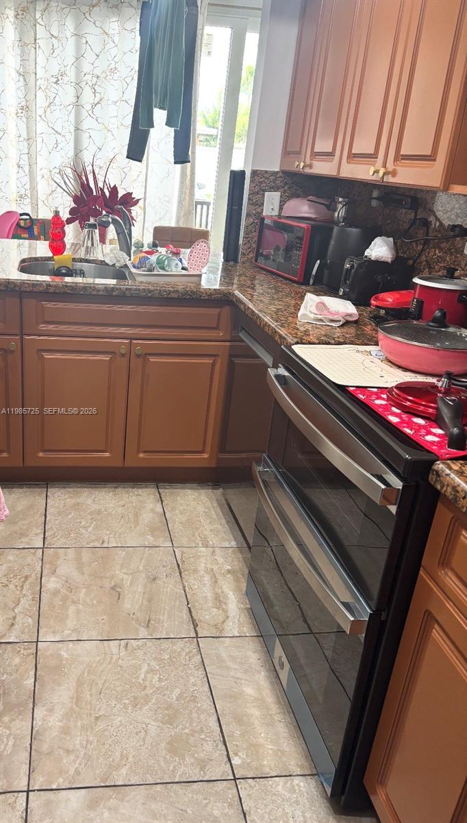 9441 Southwest 4th Street, Unit 111 Miami, FL 33174 - Photo 6 of 6 a kitchen with a sink and cabinets