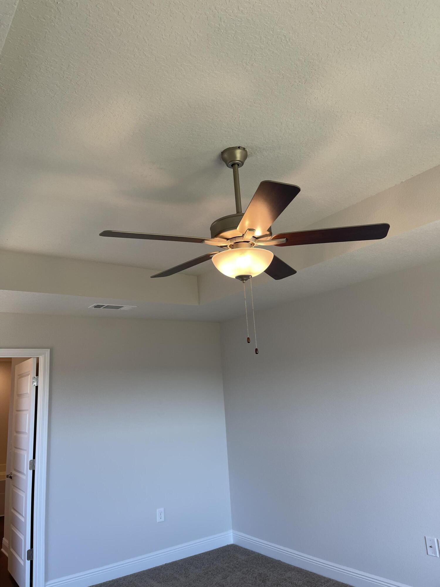 5810 Crestlake Drive Crestview, FL 32536 - Photo 19 of 22 a view of a small space with a ceiling fan and wooden floor