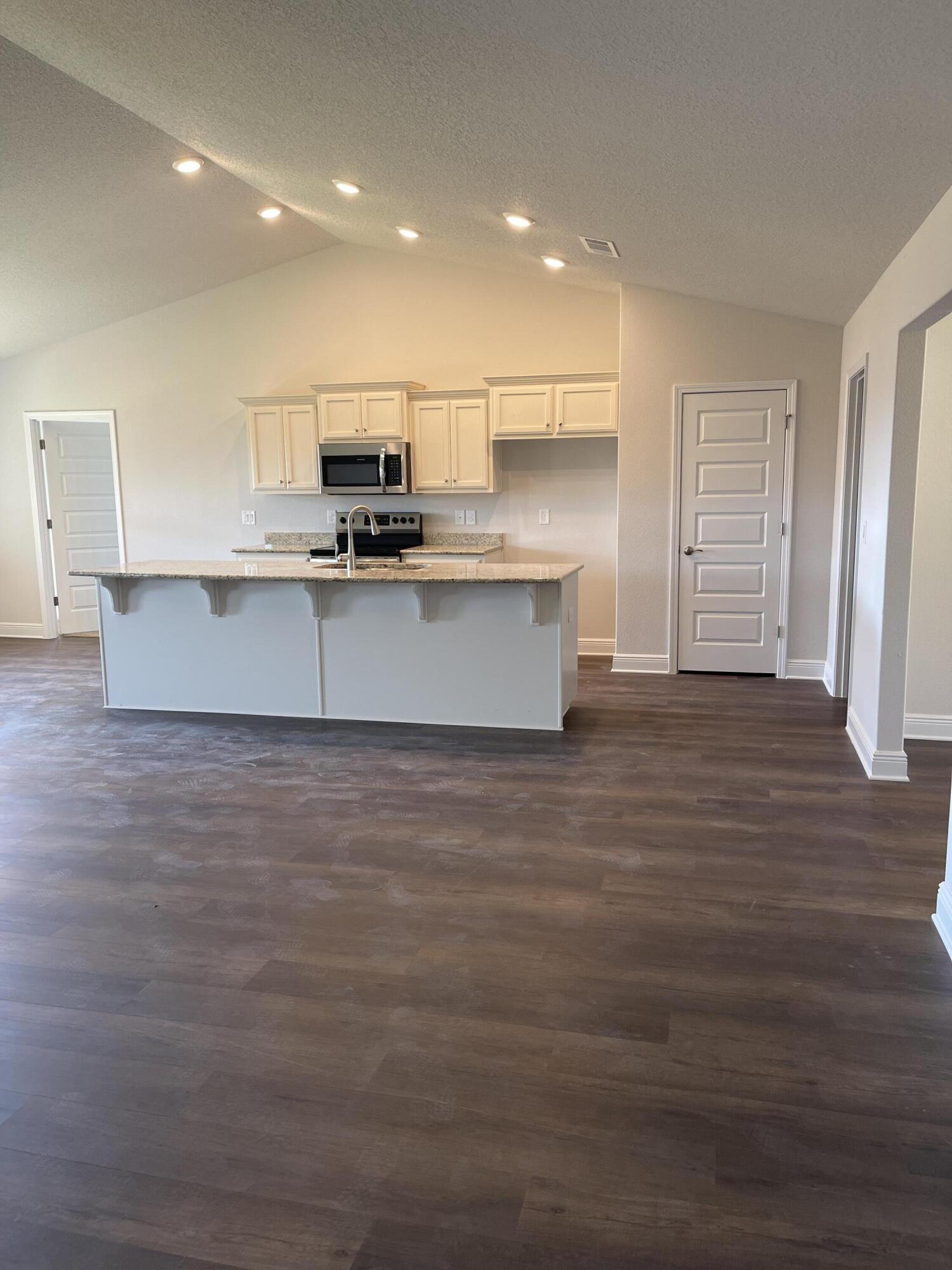 5810 Crestlake Drive Crestview, FL 32536 - Photo 9 of 22 a view of kitchen with stainless steel appliances granite countertop a stove top oven a sink and a refrigerator