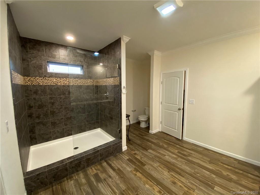 4009 Love Mill Road Monroe, NC 28110 - Photo 8 of 25 a bathroom with a bathtub and a shower