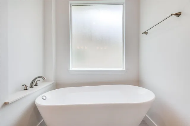 a white bath tub sitting in a bathroom