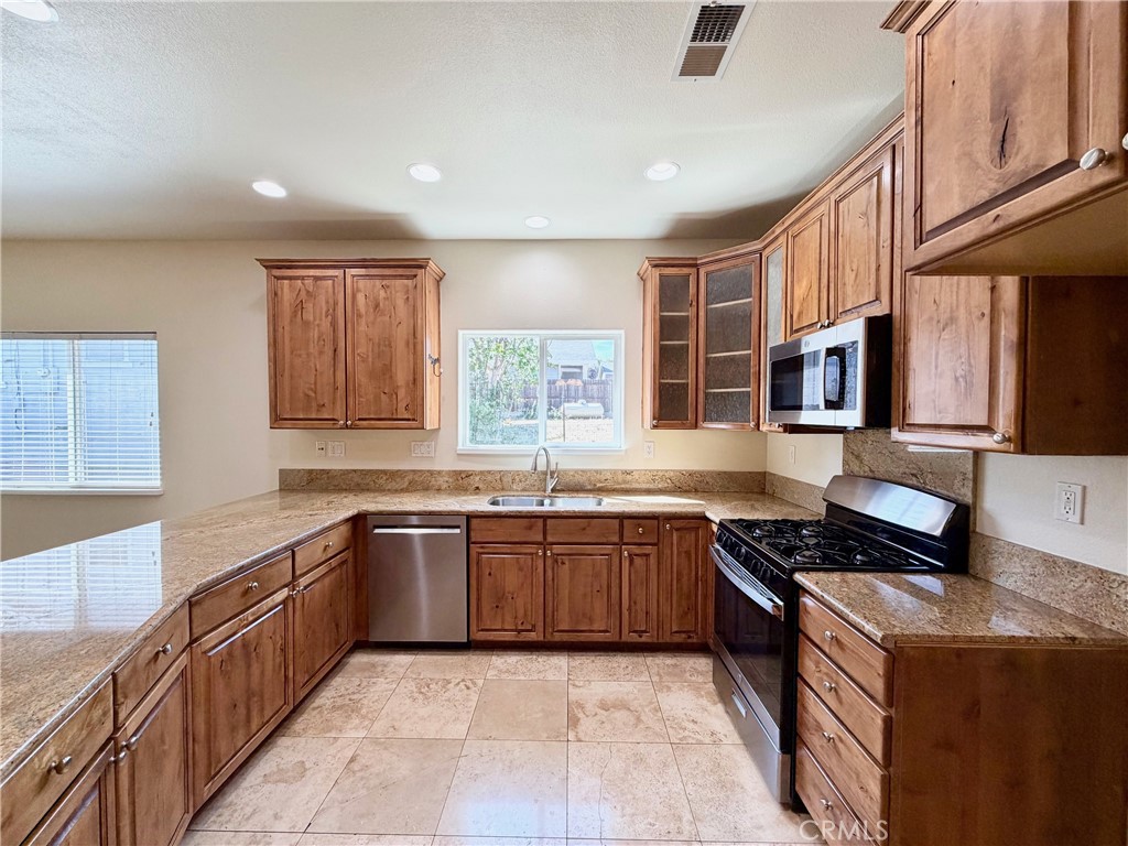 1037 Mark Twain Road Angels Camp, CA 95222 - Photo 17 of 52 a large kitchen with stainless steel appliances granite countertop a stove and a sink