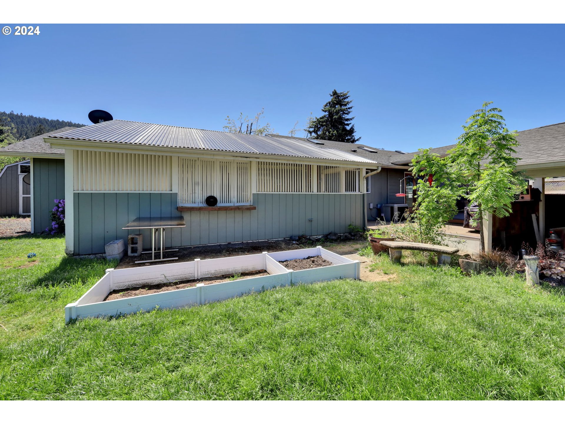 253 South 70th Place Springfield, OR 97478 - Photo 39 of 43 a view of a house with a backyard and a patio