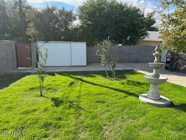 a backyard of a house with yard and trampoline