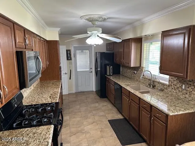 a kitchen with granite countertop stainless steel appliances a sink stove and refrigerator