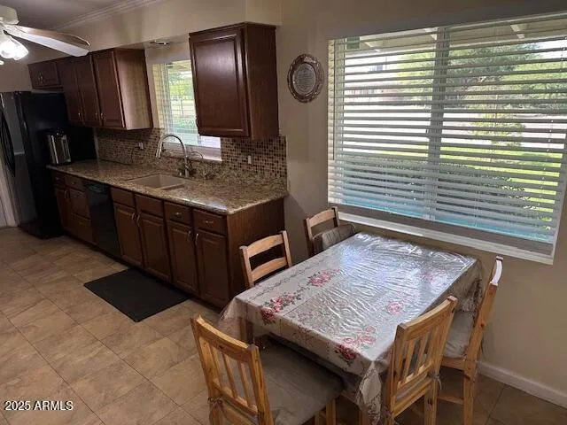 a kitchen with a sink a counter top space and stainless steel appliances