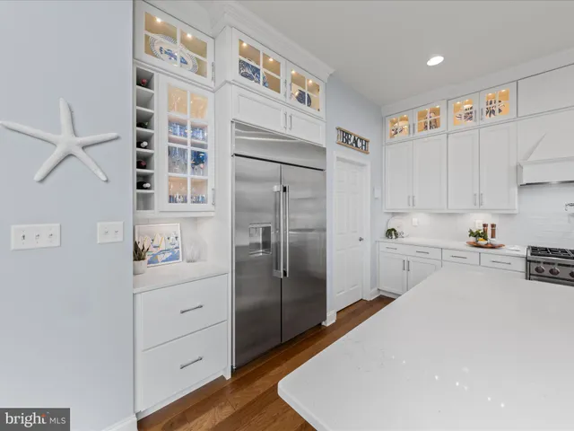 a living room with furniture large window and a fireplace