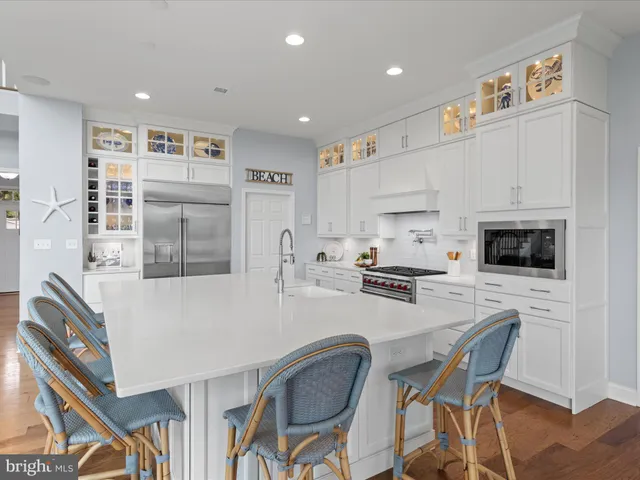 a living room with furniture a table and a large window