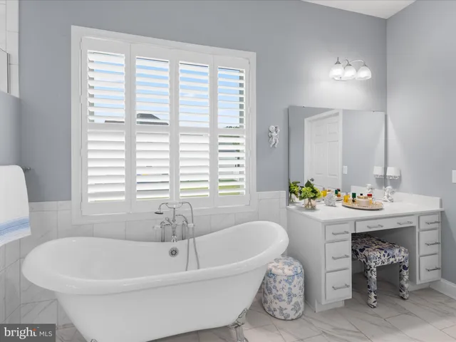 a living room with furniture and a gym machine with wooden floor
